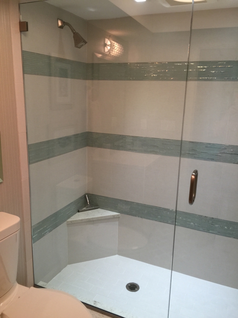 shower door and panel installed with clip and u- channel